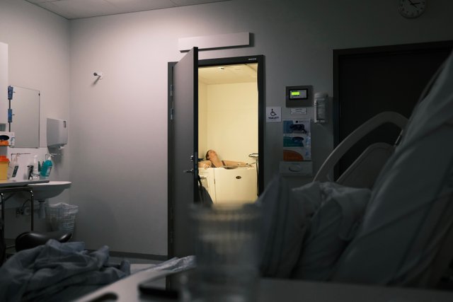 a photograph of a hospital room with a hospital bed and a hospital bed
