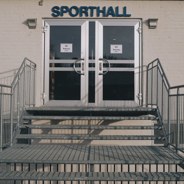 a photograph of a door to a sports hall with a sign that says sport hall