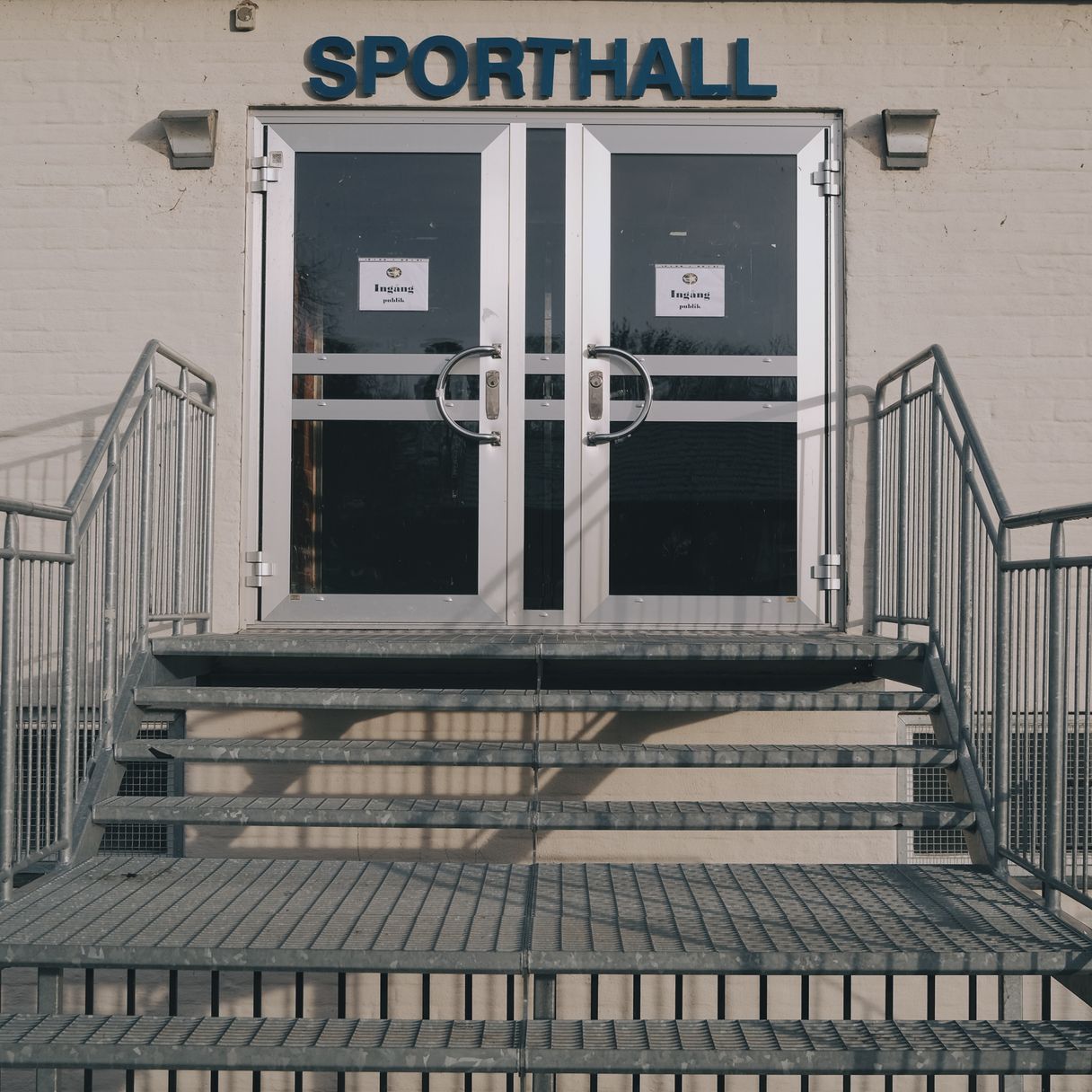 a photograph of a door to a sports hall with a sign that says sport hall