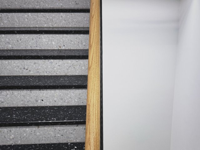a photograph of a bathroom with a toilet and a toilet paper roll