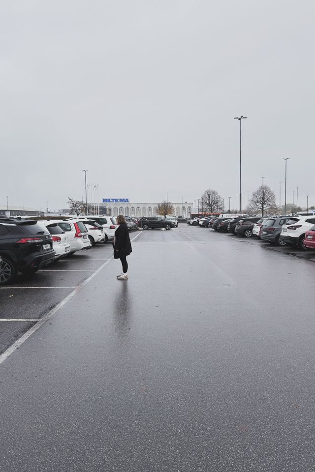 a photograph of a woman on a parking lot