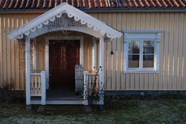 a photograph of a house with a red door and a white door