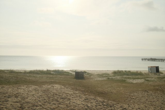 a photograph of a bench with a bench and a bench in the sand