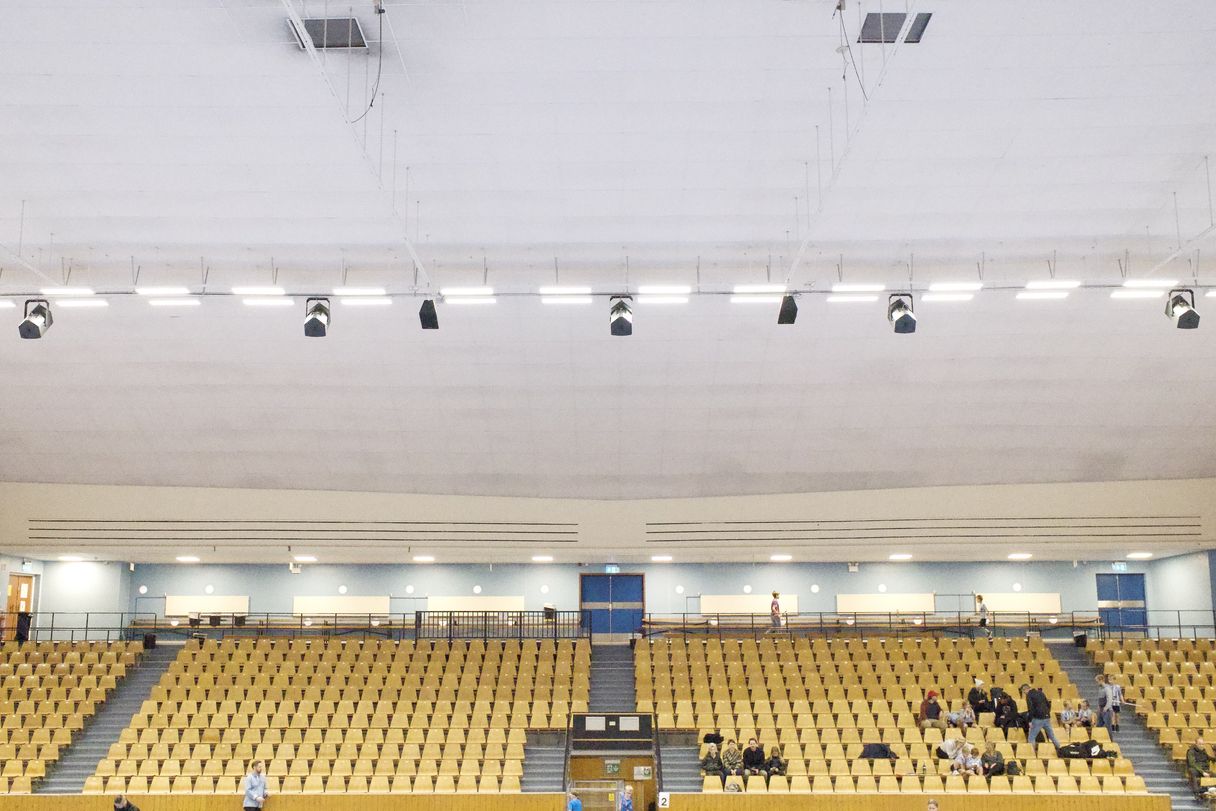 a photograph of a large room with a lot of chairs and people