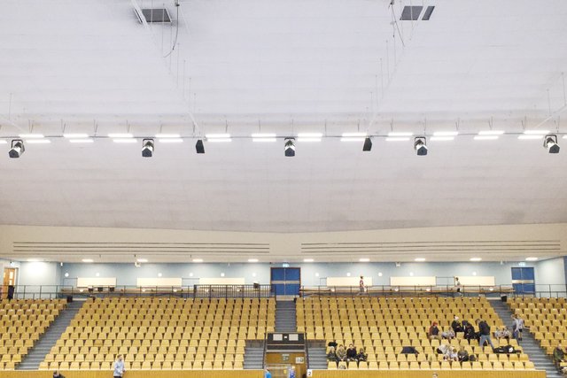 a photograph of a large room with a lot of chairs and people
